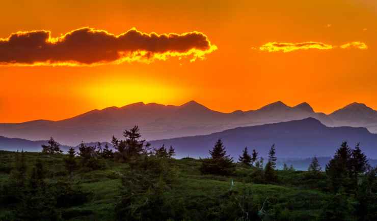 scenic view of mountains against sky at sunset